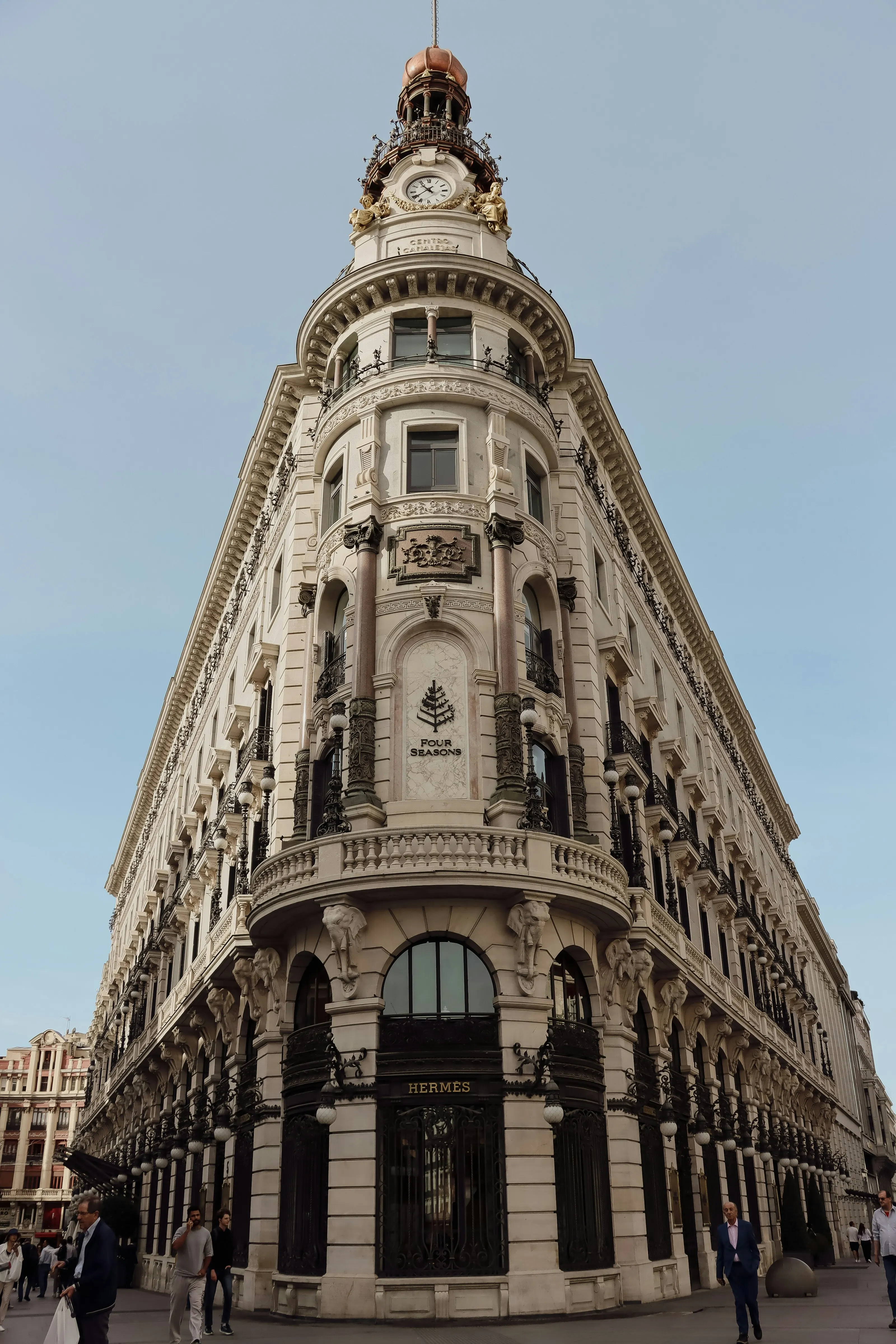 Historic neoclassical facade of Four Seasons Hotel Madrid with ornate clock tower