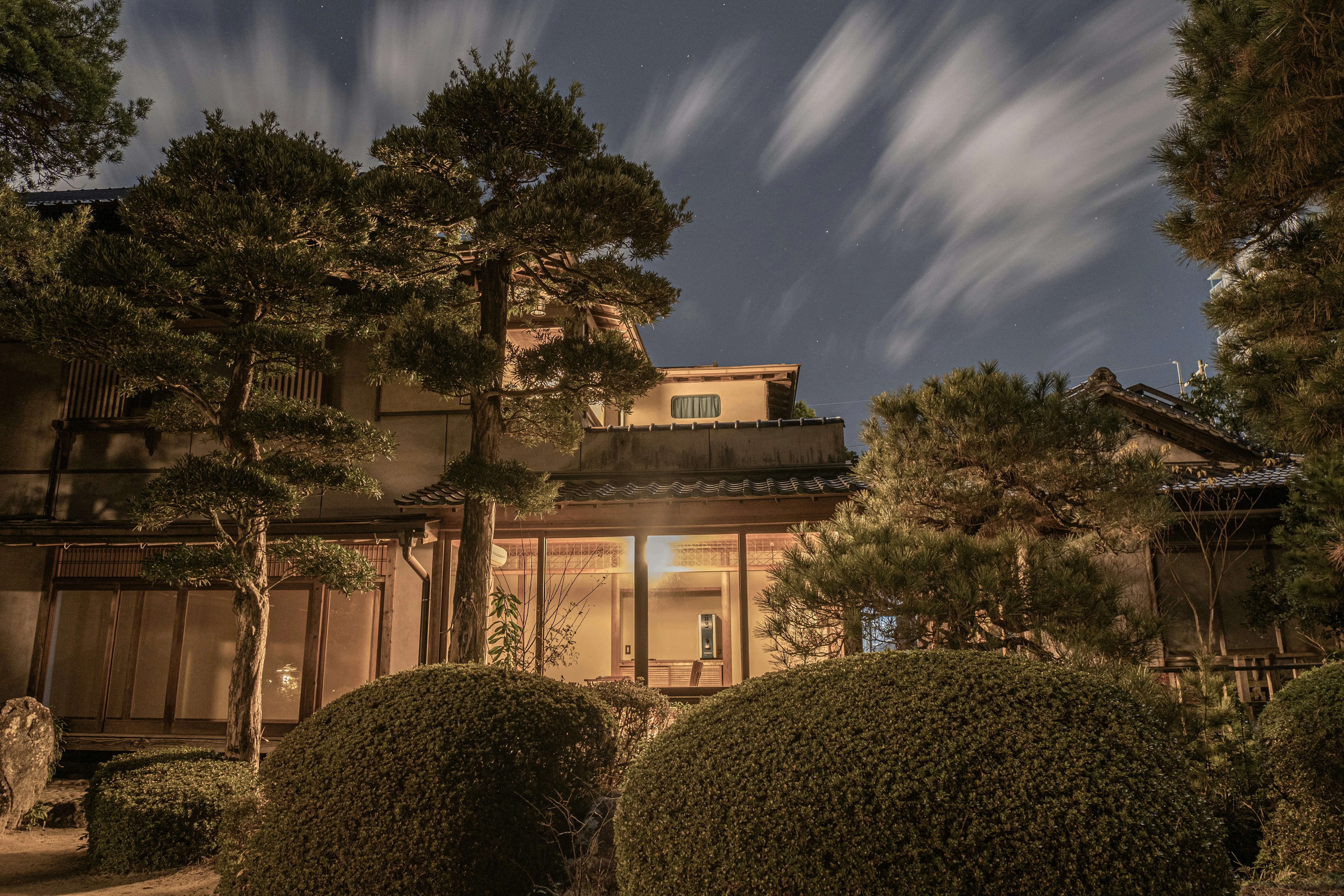 Traditional Japanese Wooden Ryokan Illuminated at Night